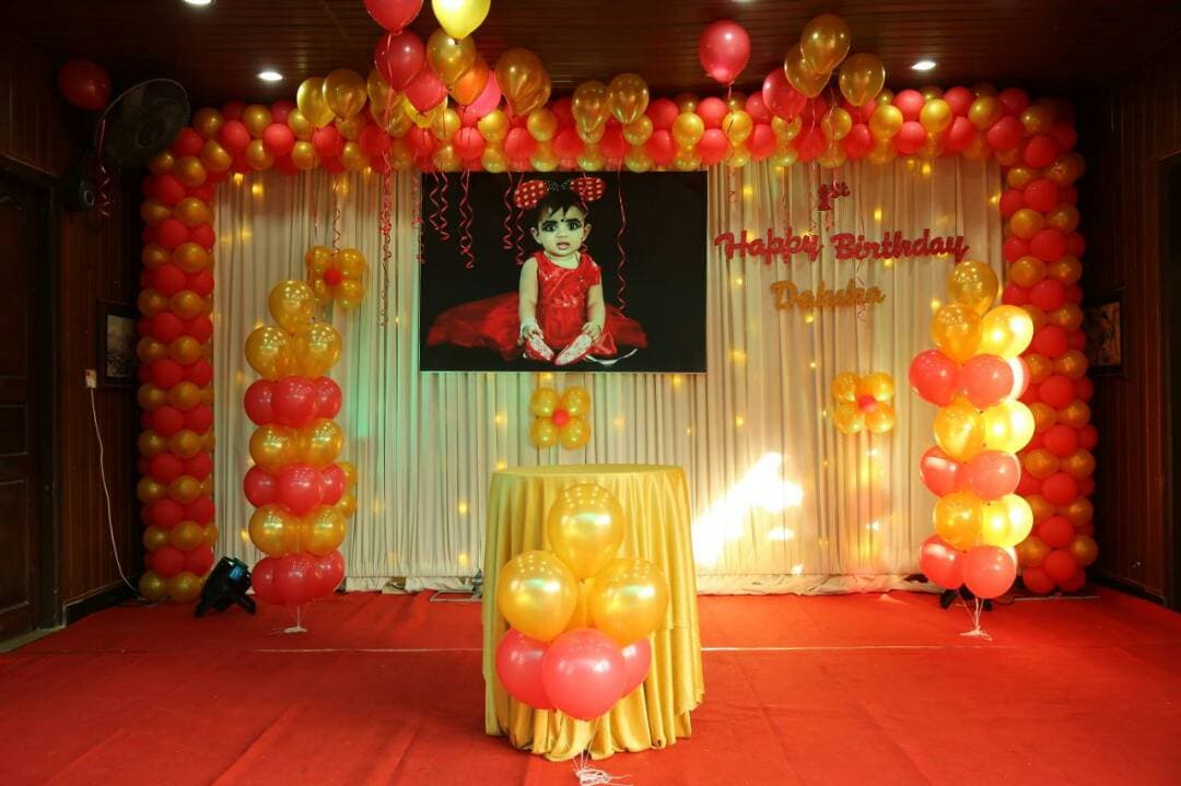 Birthday Celebration Birthday party with red and gold balloon décor by Red Q Events