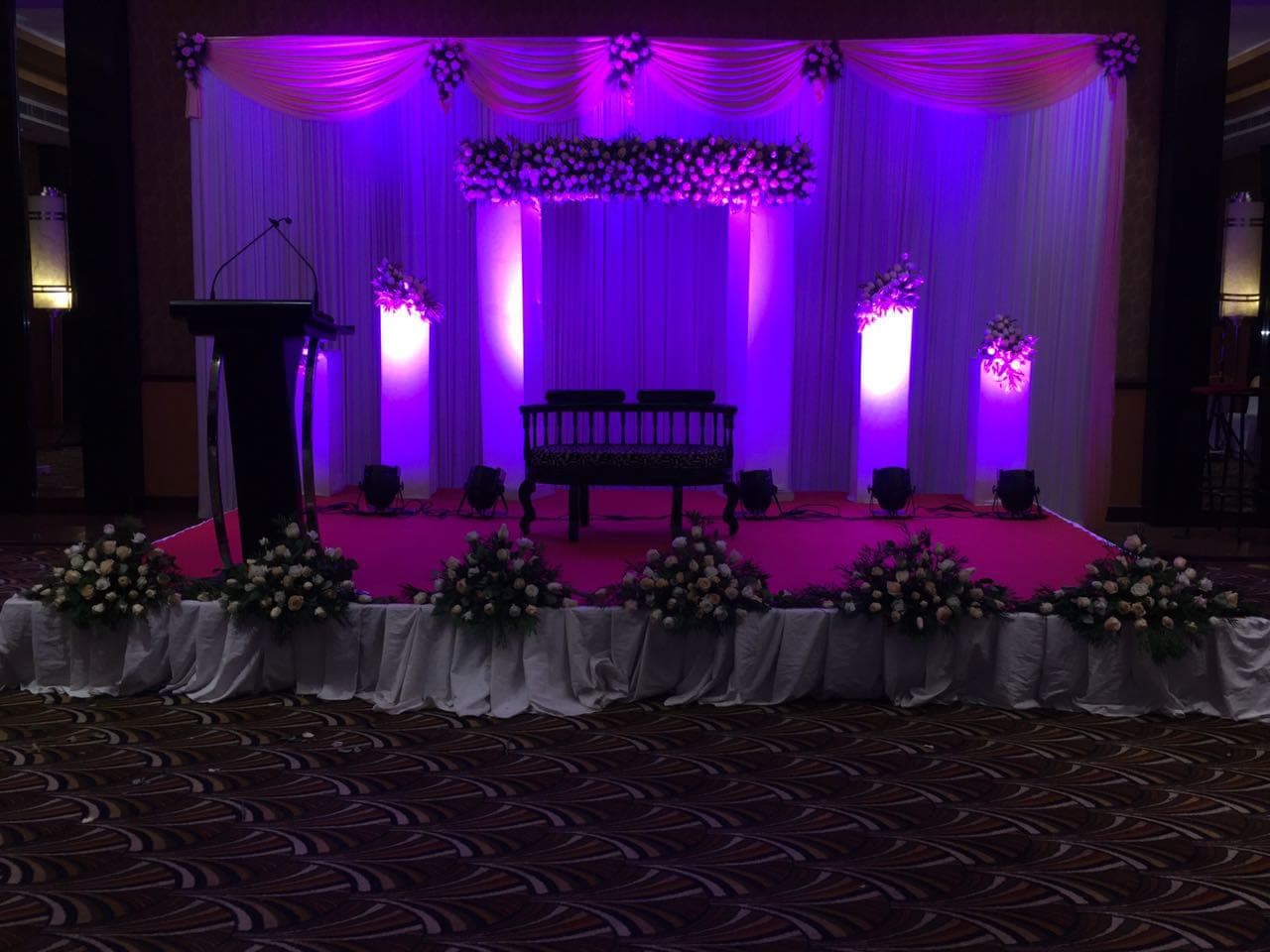 The Red Q Events story Luxury purple-lit wedding stage designed by Red Q Events